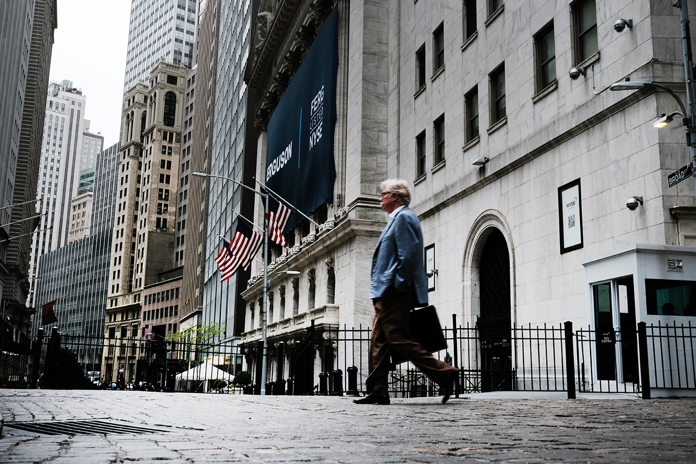 People walk by the New York Stock Exchange (NYSE) on May 12, 2022 in New York City.