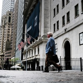 People walk by the New York Stock Exchange (NYSE) on May 12, 2022 in New York City.