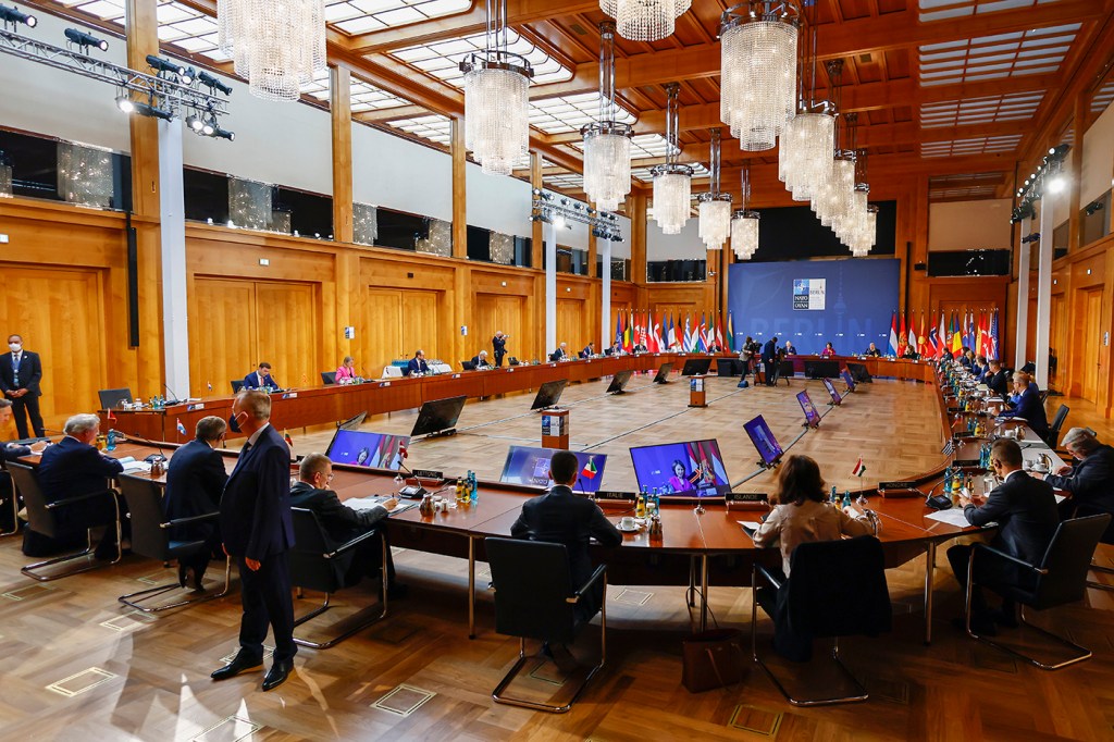 nato foreign ministers sit in a conference room