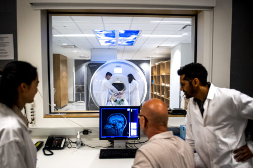 Technicians oversee an MRI exam.