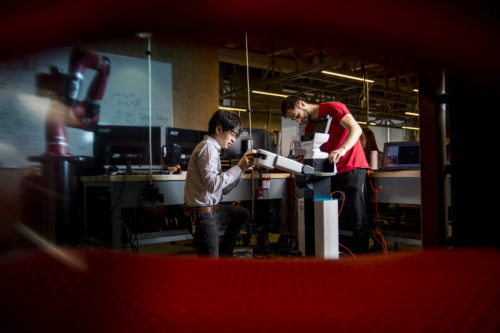 Engineering students Anas Abou Allaban and Naomi Yokoyama work on the Toyota robot in the Robotics Lab in Richards Hall on June 26, 2018. Photo by Matthew Modoono/Northeastern University