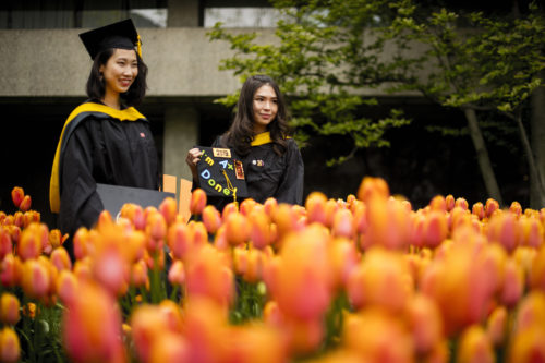 Graduates pose for photos outside of the Curry Student Center on May 10, 2019. Photo by Adam Glanzman/Northeastern University