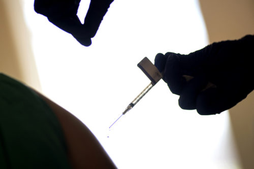 A droplet falls from a syringe after a health care worker is injected with the Pfizer-BioNTech COVID-19 vaccine at Women & Infants Hospital in Providence, R.I., on Dec. 15, 2020. AP Photo by David Goldman
