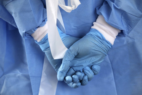 A nurse wore rubber gloves for the city's coronavirus testing site to open next to Citizens Bank Park in South Philadelphia on March 20, 2020. Tim Tai/The Philadelphia Inquirer via AP
