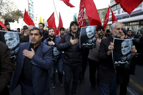 Protesters mourn during a demonstration over the U.S. airstrike in Iraq that killed Iranian Revolutionary Guard Gen. Qassem Soleimani, shown in the posters, in Tehran, Iran. AP Photo/Vahid Salemi