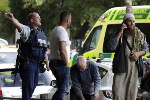 Police attempt to clear people from outside a mosque in central Christchurch, New Zealand, Friday, March 15, 2019. 49 people were killed in a mass shooting at a mosque in the New Zealand city of Christchurch on Friday. (AP Photo/Mark Baker)