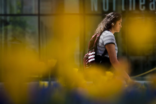 A member of the Northeastern community walks down Forsyth Ave on the Boston campus. Photo by Alyssa Stone/Northeastern University