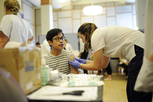 10/14/15 - BOSTON, MA. - Gerard Rambaud, E'18, receives a flu vaccine from Athena Crowley, BHS'17, during the Bouvé College of Health Sciences Health Fair and Flu Clinic held in the Curry Student Center Ballroom at Northeastern University on Oct. 14, 2015. Staff Photo: Matthew Modoono/Northeastern University