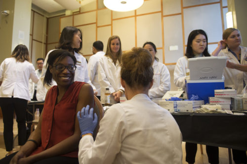 Students can still get free flu shots at Northeastern's UHCS on Forsyth Street. Above, a student receives a flu vaccine at the annual Bouvé Health Fair and Flu Shot Clinic held in the fall. <i>Photo by Adam Glanzman/Northeastern University</i>