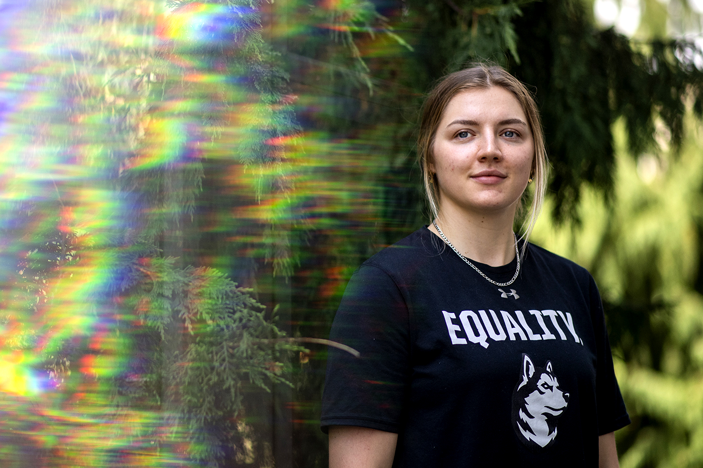 blonde woman wearing black shirt with a husky and the word 'equality' written in all caps on it