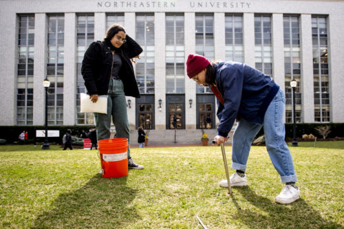 Northeastern Arboretum third year co-op Indira Holdsworth, an ecology and evolutionary biology major, and Northeastern Arboretum co-op Nadia Plaschke, a fourth-year student majoring in environmental studies and international affairs, take soil samples to asses soil quality at Krentzman Quad. Photo by Matthew Modoono/Northeastern University