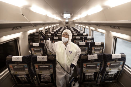 An employee sprays disinfectant on a train as a precaution against a new coronavirus at Suseo Station in Seoul, South Korea on Friday, Jan. 24, 2020. China broadened its unprecedented, open-ended lockdowns to encompass around 25 million people Friday to try to contain a deadly new virus that has sickened hundreds, though the measures' potential for success is uncertain. AP Photo/Ahn Young-joon