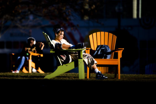 Students enjoy the afternoon sun while studying on Centennial Common during finals week. Photo by Matthew Modoono/Northeastern University