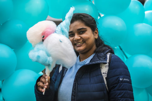 Northeastern information system major Tejal Bhalerao poses for a photograph with the unicorn cotton-candy she received at the Northeastern University dining’s DelightFul Challenge in Snell Quad. Photo by Alyssa Stone/Northeastern University