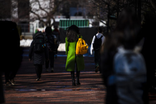 A member of the Northeaster community walks through the Boston campus. Photo by Alyssa Stone/Northeastern University