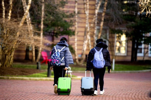 Students walk past West Village H on the last day of finals. Photo by Matthew Modoono/Northeastern University