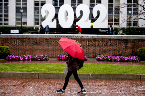 Workers install a giant 2022 sign on Krentzman Quad in preparation for Commencement week. Photo by Matthew Modoono/Northeastern University