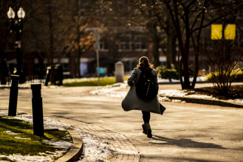 A member of the Northeastern community walks through campus. Photo by Alyssa Stone/Northeastern University