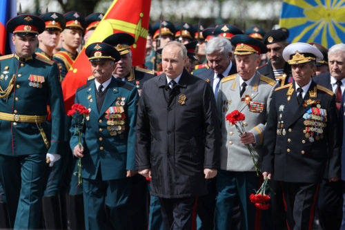 Russian President Vladimir Putin, centre, attends a wreath-laying ceremony at the Tomb of the Unknown Soldier after the military parade marking the 77th anniversary of the end of World War II, in Moscow, Russia, Monday, May 9, 2022. Anton Novoderezhkin, Sputnik, Kremlin Pool Photo via AP