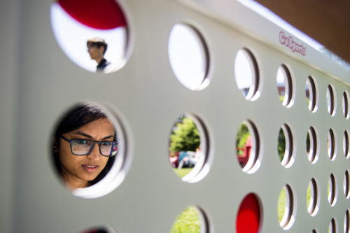 Raksha Kagadalu Raju, who studies information science, ponders her next move during a giant connect 4 game at the cream social on Centennial Common. Photo by Matthew Modoono/Northeastern University