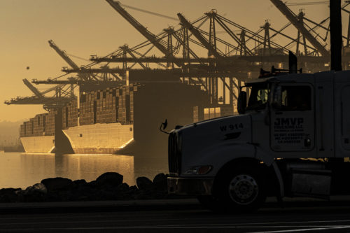 A truck arrives to pick up a shipping container near vessels moored at Maersk APM Terminals Pacific at the Port of Los Angeles. The Port of Los Angeles is on track to move a record volume of import cargo this year. Officials at the nation's busiest port expect to hit the new mark, even as they struggle to clear a backup of ship traffic and ease supply chain snarls that have been blamed for product shortages and higher shelf prices.