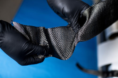 Anvesh Gurijala shows carbon fiber materials at Boston Materials, which is located on the Northeastern University Innovation Campus in Burlington, Massachusetts. Photo by Matthew Modoono/Northeastern University