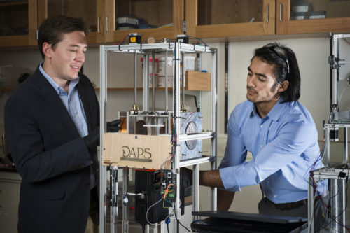 10/15/15 - BOSTON, MA. - Professor Randall Erb and his student Joshua Martin work with a 3D printer that Martin developed that uses magnets in Egan on Oct. 15, 2015. Photo by Adam Glanzman/Northeastern University