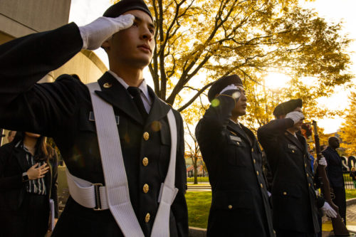 uniformed rotc students stand at salute