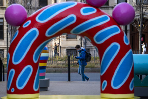  A member of the Northeastern community walks by the new art installation in Richardson Plaza by CHIAOZZA, couple Terri Chiao and Adam Frenzza. Photo by Alyssa Stone/Northeastern University