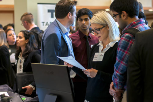 Students and employer representatives network  during the On Fire to Hire Startup Expo in the Curry Student Center Ballroom in October 2015.