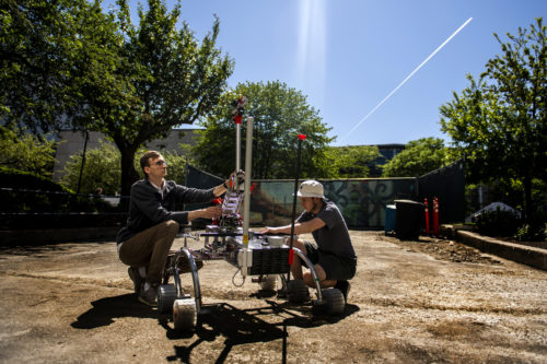 NUROVER team lead Garrit Strenge and electrical lead Benjamin Thacher prepare to test their mock Mars rover, Watney Mark 3.0, in advance of the Mars Society's University Rover Challenge. Photo by Matthew Modoono/Northeastern University