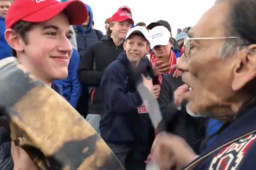 A photo that depicts a teenager in a red “Make America Great Again” hat smiling and standing in front of a Native American elder has circulated widely on social media and generated national outrage. Photo by YouTube. 