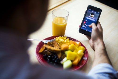 A student uses Northeastern DIning's new app during breakfast in the Stetson East dining hall on September 26, 2018. Photo by Adam Glanzman/Northeastern University