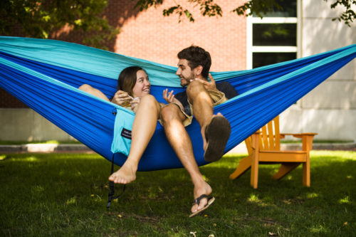  Kelsey Powers, a mechanical engineering major, and Matt Wikstrom, a music industry major, sit in a hammock on Centennial Common on August 6, 2018. Photo by Adam Glanzman/Northeastern University