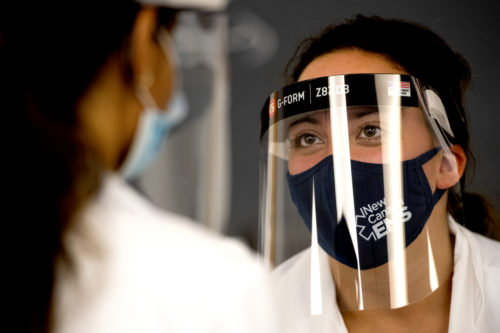 Graduate students in Northeastern's Physician Assistant Program wear face shields, masks, and gloves while practicing physical exam skills in class. Photo by Matthew Modoono/Northeastern University