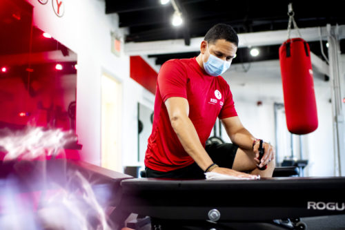 Hector Plaza, co-owner of Red City Fitness, sanitizes equipment in the fitness studio. The law students at Northeastern’s Community Business Clinic helped him create a plan to reopen safely. Photo by Ruby Wallau/Northeastern University