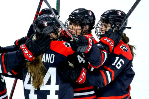 Alina Mueller, center, celebrates a goal during the 5-0 victory over Boston College. Mueller will attend the 2022 Beijing Winter Olympics. Photo by Jim Pierce/Northeastern Athletics