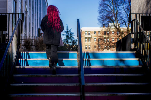 A member of the Northeastern community climbs the stairs by the Curry Student Center. Photo by Alyssa Stone/Northeastern University