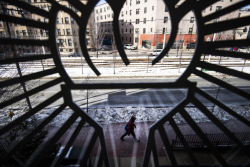 A student walks by the Knowles Center at the School of Law on March 6, 2019. Photo by Adam Glanzman/Northeastern University