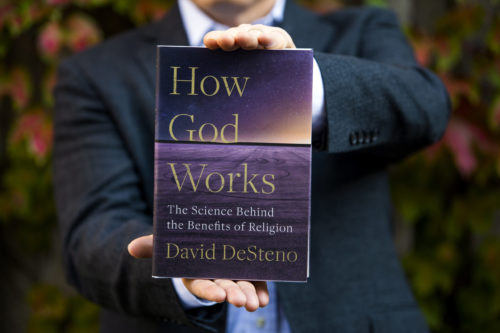 David DeSteno holds a copy of his new book, 