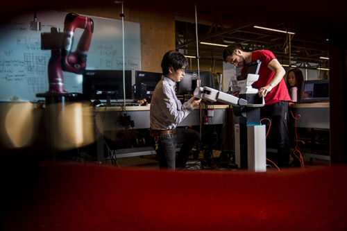 Engineering students Anas Abou Allaban and Naomi Yokoyama work on the Toyota robot in the Robotics Lab in Richards Hall on June 26, 2018. They were part of a team that competed in a robotics competition called Robocup@Home. Photo by Matthew Modoono/Northeastern University