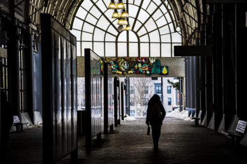 A Northeastern student walks through the Ruggles train station. Photo by Alyssa Stone/Northeastern University