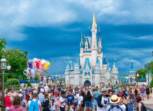 Crowd of people at the Cinderella Castle in Walt Disney World. Photo by Roberto Machado Noa/LightRocket via Getty Images