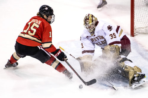 Northeastern's Mia Brown challenges Boston College goalie Abigail Levy at the semifinal of the Women's Beanpot.