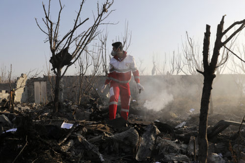A rescue worker searches the scene where an Ukrainian plane crashed in Shahedshahr, southwest of the capital Tehran, Iran, Wednesday, Jan. 8, 2020. A Ukrainian airplane carrying 176 people crashed on Wednesday shortly after takeoff from Tehran's main airport, killing all onboard. AP Photo/Ebrahim Noroozi