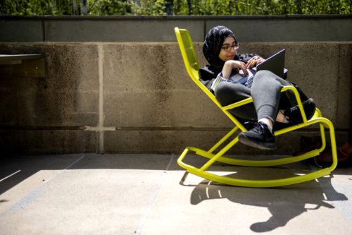 Law school student Asmaa Hamdan, works on a project on Robinson Quad. Photo by Matthew Modoono/Northeastern University