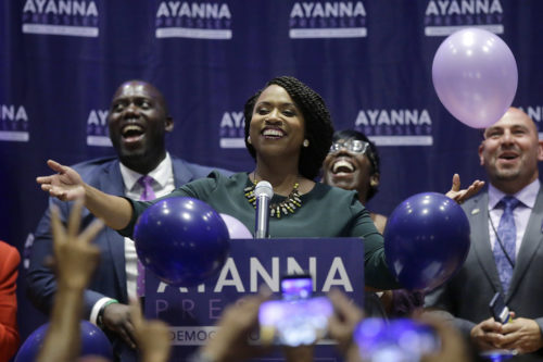 Boston City Councilor Ayanna Pressley, center, celebrates victory over U.S. Rep. Michael Capuano in the 7th Congressional House Democratic primary on Tuesday, Sept. 4, 2018, in Boston. (AP Photo/Steven Senne)
