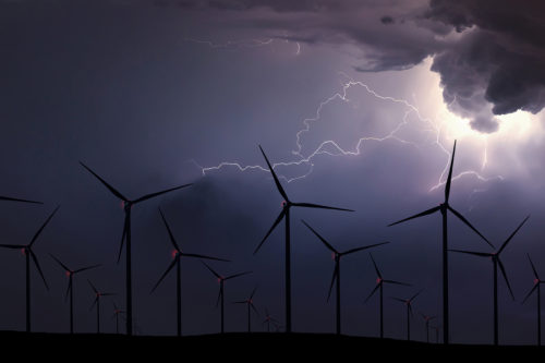 Storm Night Over Wind Farm. Energy and nature Night Sky.