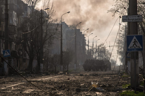 Donetsk People's Republic BTR armoured personnel carriers drive through a burning street in Eastern Mariupol. The battle between Russian / Pro Russian forces and the defending Ukrainian forces led by the Azov battalion continues in the port city of Mariupol. Photo by Maximilian Clarke/SOPA Images/LightRocket via Getty Images
