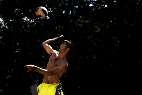 Tyler Mangini, E'18, makes a serve during a volleyball game in West Village H on Friday afternoon. Photo by Matthew Modoono/Northeastern University